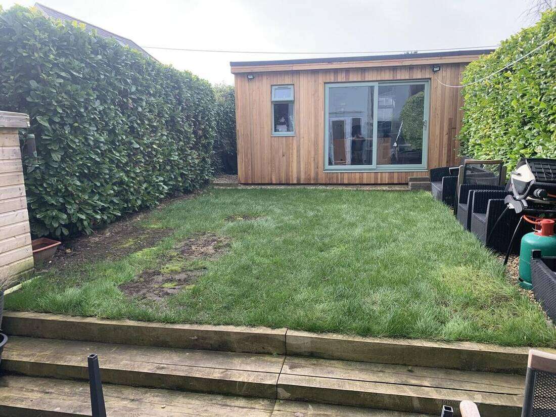 Cedar-clad garden room on a lawn