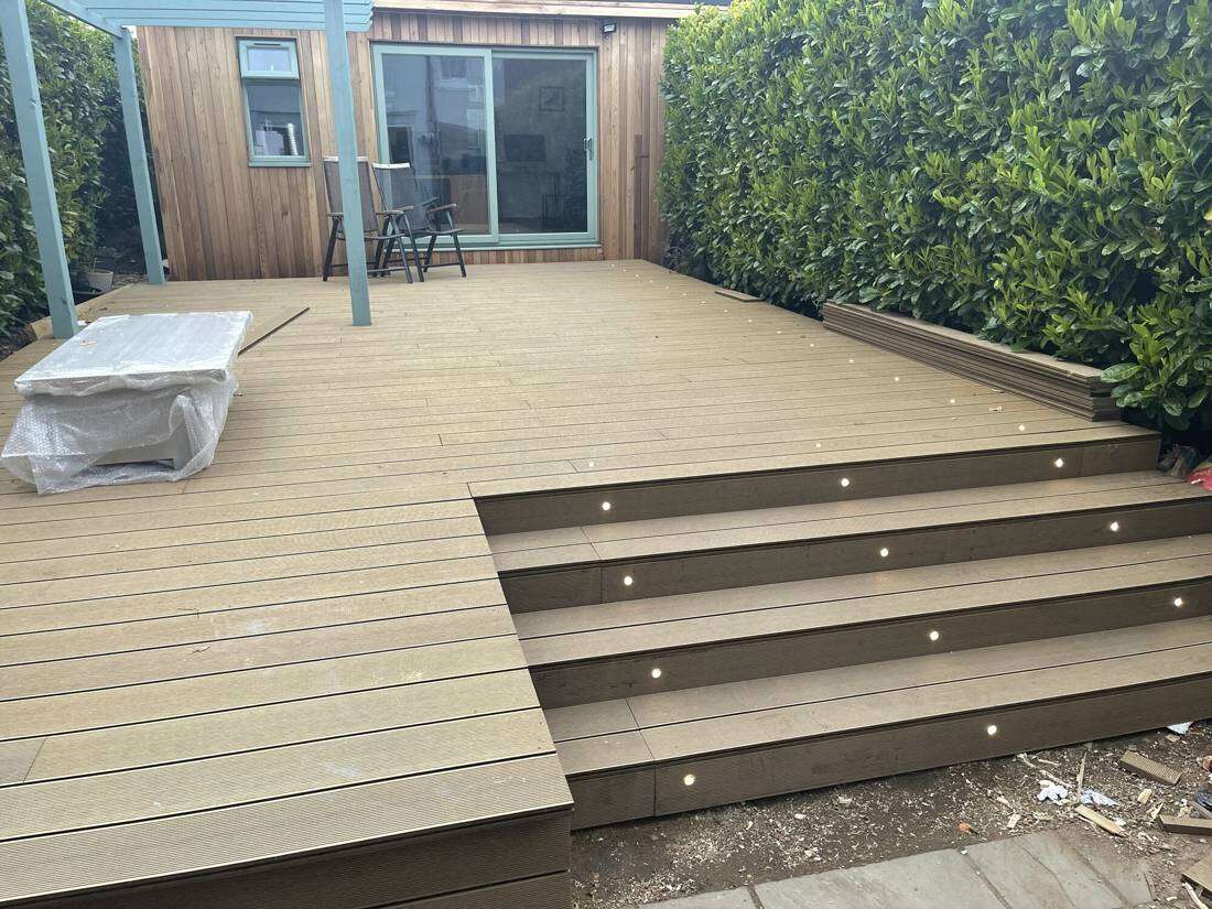 Deck steps up to a garden room