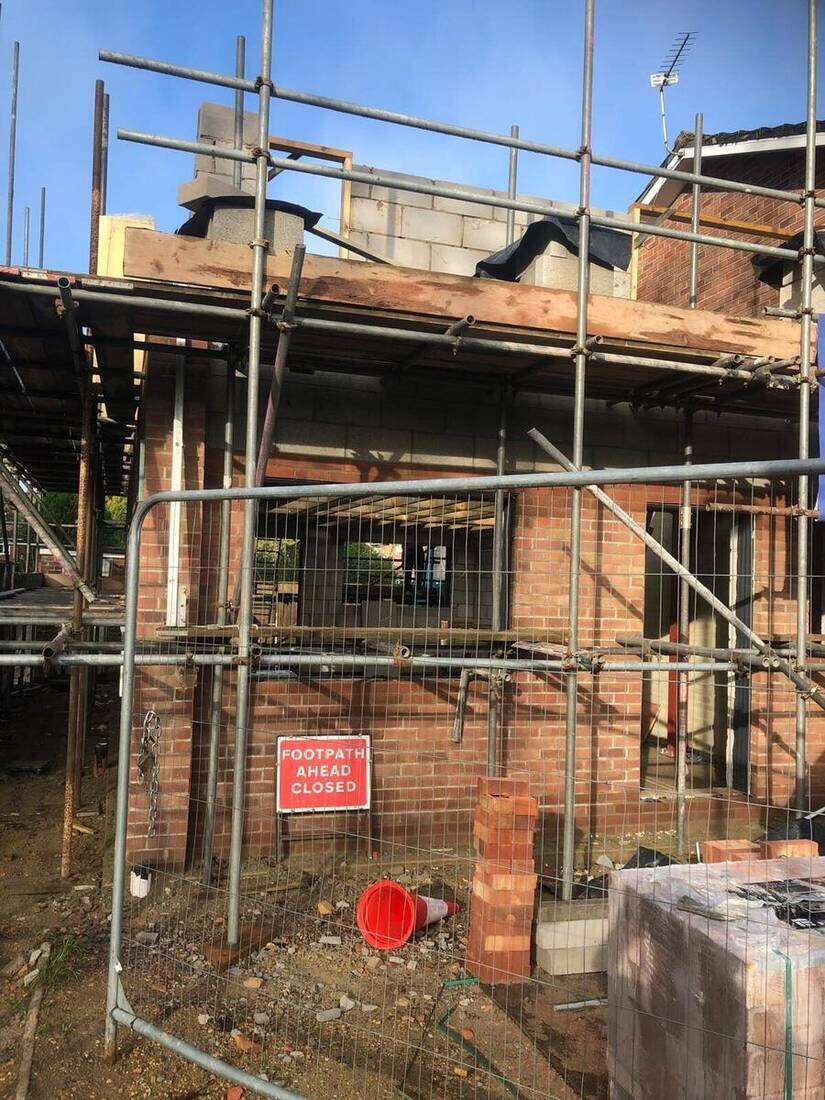 Extension walls going up under scaffold