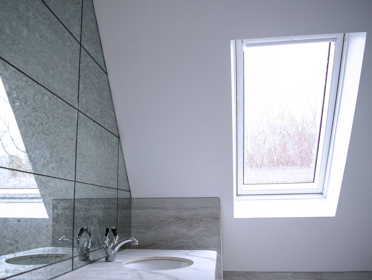 Loft en-suite basin under a rooflight