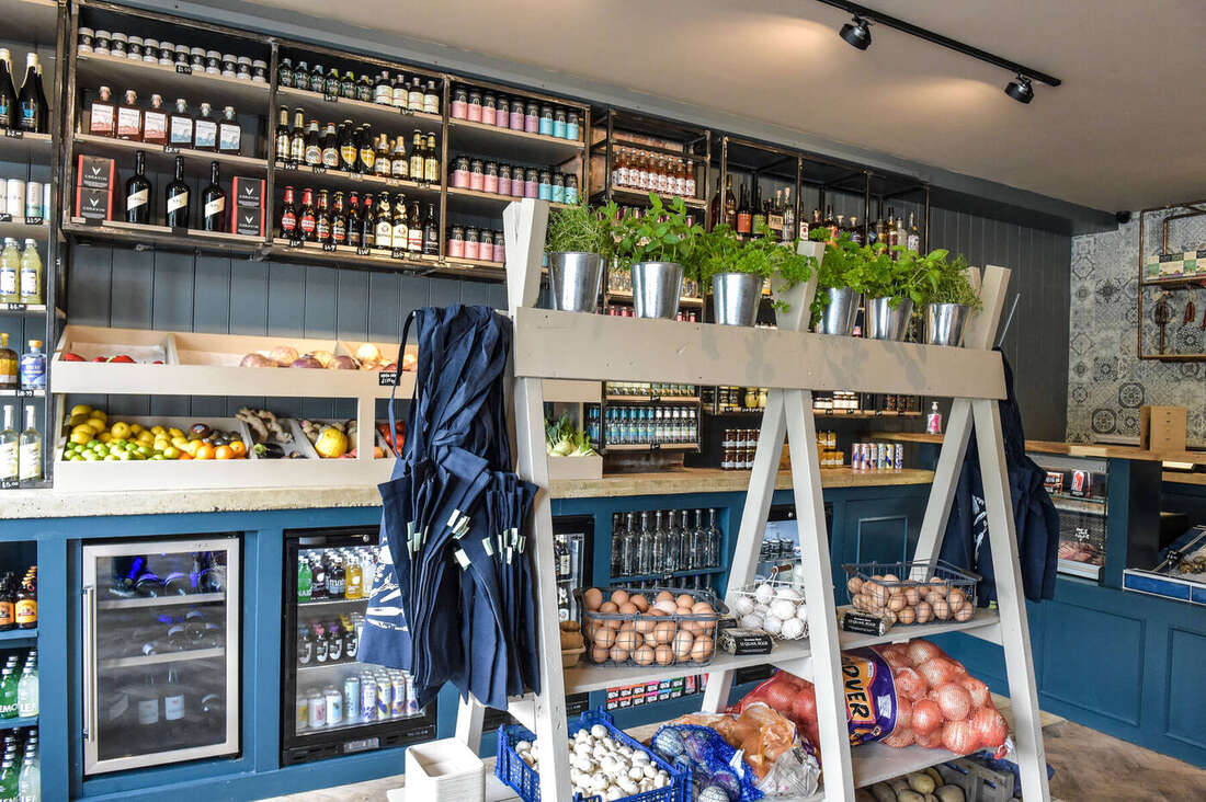 Inside the deli: produce stands and shelving