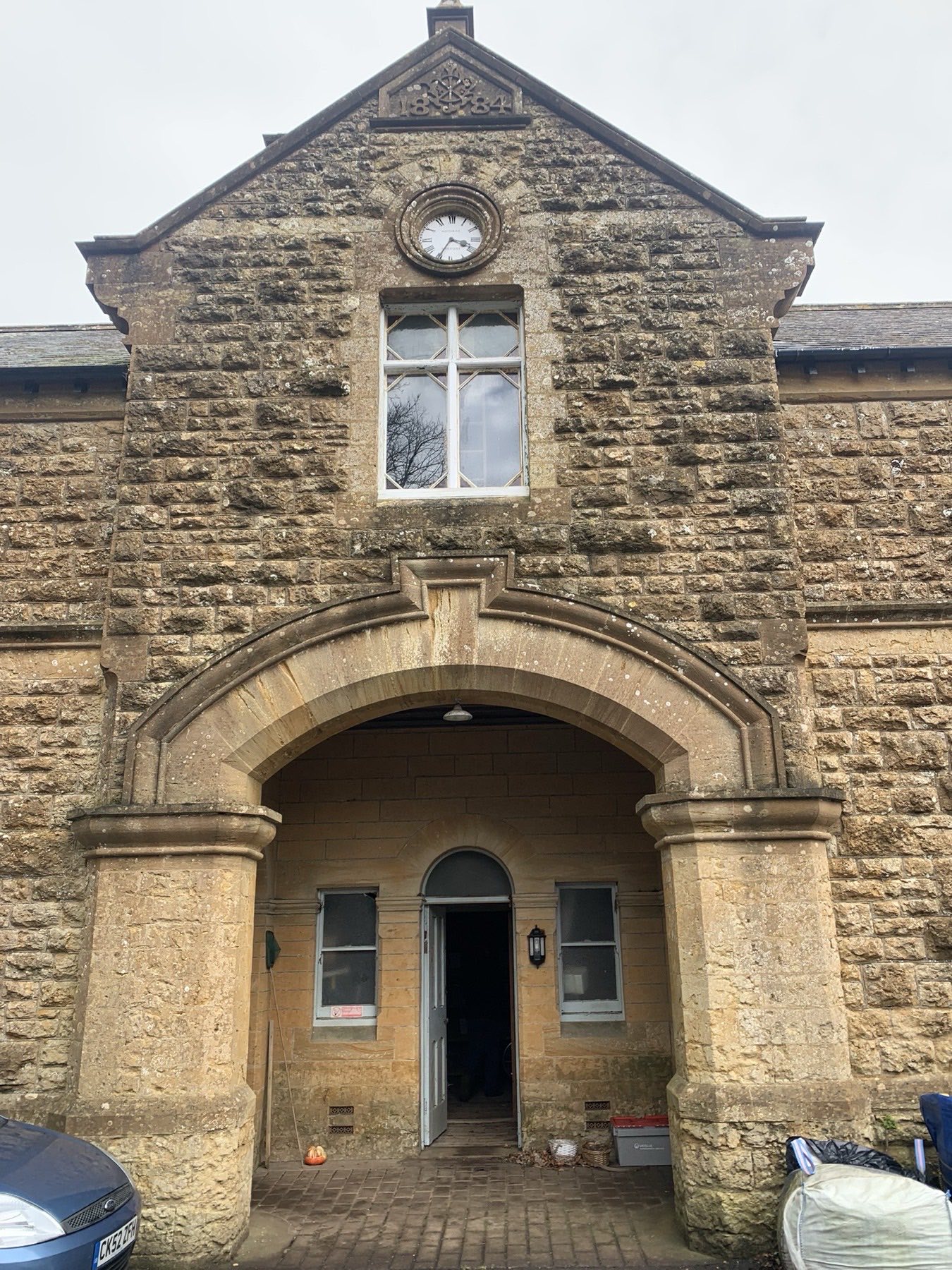 The 1884 Grade II listed stable block at Hyde Care Home, Walditch — clock tower and arched entrance